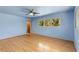 Light blue bedroom with hardwood floors and bright natural light at 2850 Bon Air Ave, Sarasota, FL 34234
