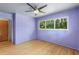 The bedroom has hardwood floors, a ceiling fan, and a large window at 2850 Bon Air Ave, Sarasota, FL 34234