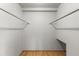 Empty walk-in closet with hardwood floors and hanging rods at 2850 Bon Air Ave, Sarasota, FL 34234