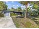 Street view of a charming single-story home with mature landscaping in a quiet neighborhood at 2850 Bon Air Ave, Sarasota, FL 34234