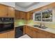 A compact vintage kitchen featuring stainless steel sink and built-in oven at 2850 Bon Air Ave, Sarasota, FL 34234