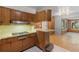 A compact vintage kitchen with stainless steel appliances and wood cabinets at 2850 Bon Air Ave, Sarasota, FL 34234