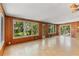 Spacious living area featuring wood paneled walls and large windows with backyard view at 2850 Bon Air Ave, Sarasota, FL 34234