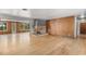 Bright living room featuring original hardwood floors and a stone fireplace at 2850 Bon Air Ave, Sarasota, FL 34234