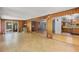 Open living room with wood paneling, fireplace, and sliding door access to the backyard at 2850 Bon Air Ave, Sarasota, FL 34234
