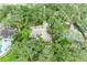 Aerial view showcasing a home with lush landscaping and mature trees, set in a serene and private setting at 3217 Oak Grove Dr, Sarasota, FL 34243