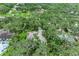 Aerial view highlighting the property's setting amidst lush foliage and mature trees for added privacy at 3217 Oak Grove Dr, Sarasota, FL 34243