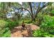Backyard brick patio surrounded by lush landscaping at 3217 Oak Grove Dr, Sarasota, FL 34243