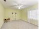 Bright and airy bedroom with neutral carpeting and a ceiling fan with light fixture at 3217 Oak Grove Dr, Sarasota, FL 34243