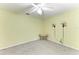 Bedroom with ceiling fan, neutral carpet, and decorative wall sconces at 3217 Oak Grove Dr, Sarasota, FL 34243