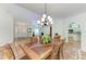 Dining room with terracotta tile flooring, dark wood table, six chairs, and chandelier at 3217 Oak Grove Dr, Sarasota, FL 34243