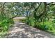 Charming home with long driveway and lush trees along the side at 3217 Oak Grove Dr, Sarasota, FL 34243