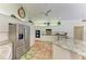 Bright kitchen with stainless steel appliances, granite counters and terracotta tile flooring at 3217 Oak Grove Dr, Sarasota, FL 34243