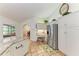 Bright kitchen featuring stainless steel refrigerator, granite countertops, and desk area at 3217 Oak Grove Dr, Sarasota, FL 34243