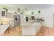Bright kitchen with stainless steel appliances, granite counters and terracotta tile flooring at 3217 Oak Grove Dr, Sarasota, FL 34243