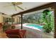 This screened-in lanai has brick flooring and a partial view of the swimming pool at 3217 Oak Grove Dr, Sarasota, FL 34243