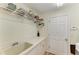 Laundry room with a stainless steel sink and storage shelf above at 3217 Oak Grove Dr, Sarasota, FL 34243