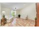 Bright living room with two couches, terracotta tile flooring, and large windows at 3217 Oak Grove Dr, Sarasota, FL 34243