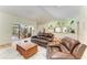 Comfortable living room with terracotta flooring, view to kitchen, and access to outdoor patio at 3217 Oak Grove Dr, Sarasota, FL 34243