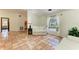 Bright living room with white couch, terracotta tile flooring, and large window at 3217 Oak Grove Dr, Sarasota, FL 34243
