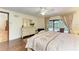Main bedroom featuring hardwood floors, a decorative dresser, and access to the backyard swimming pool at 3217 Oak Grove Dr, Sarasota, FL 34243