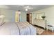 Main bedroom with an ensuite bath, decorative dresser, and hardwood floors at 3217 Oak Grove Dr, Sarasota, FL 34243