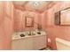 Stylish powder room with decorative wallpaper and tile countertop at 3217 Oak Grove Dr, Sarasota, FL 34243