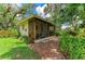 Exterior of shed with screened in porch and brick path at 3217 Oak Grove Dr, Sarasota, FL 34243