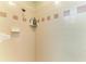 This tiled shower is accented with a band of decorative pink square tile accents at 3217 Oak Grove Dr, Sarasota, FL 34243