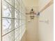 Shower featuring glass block wall, toiletry storage and a chrome shower head at 3217 Oak Grove Dr, Sarasota, FL 34243