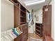 Spacious walk-in closet with custom shelves, hanging racks, and storage drawers at 3217 Oak Grove Dr, Sarasota, FL 34243