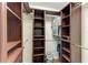 Walk-in closet with ample storage with hanging rods, shelving, and a suitcase at 3217 Oak Grove Dr, Sarasota, FL 34243