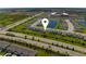 An aerial view showcases this community with lush green spaces and a serene pond, highlighting the neighborhood layout at 3355 Hilltop Cir, Bradenton, FL 34211