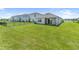 Expansive backyard with well-maintained lawn and a covered patio in a fenced yard at 3355 Hilltop Cir, Bradenton, FL 34211