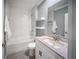 Modern bathroom featuring a tub and shower combination, floating shelves, and a vanity at 3355 Hilltop Cir, Bradenton, FL 34211