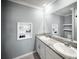 Elegant bathroom featuring granite countertops, dual sinks, and decorative shelving at 3355 Hilltop Cir, Bradenton, FL 34211