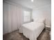 Cozy bedroom with white bedding, sheer curtains, and plush carpeting at 3355 Hilltop Cir, Bradenton, FL 34211