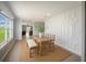 Bright dining room featuring an accent wall and light wood furniture on a jute rug at 3355 Hilltop Cir, Bradenton, FL 34211