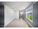 Bright, empty room with grey walls, accent wall and tile floors at 3355 Hilltop Cir, Bradenton, FL 34211