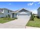 Charming single Gathering home with a well-manicured lawn and two car garage on a sunny day at 3355 Hilltop Cir, Bradenton, FL 34211