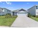 Charming single Gathering home with a well-manicured lawn and two car garage on a sunny day at 3355 Hilltop Cir, Bradenton, FL 34211