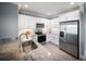 Bright kitchen featuring granite countertops, stainless steel appliances, and white cabinetry at 3355 Hilltop Cir, Bradenton, FL 34211
