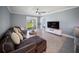 Comfortable living room with large windows, a ceiling fan, and backyard views at 3355 Hilltop Cir, Bradenton, FL 34211