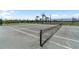 Outdoor tennis court featuring a well-maintained surface, net, and perimeter fencing for community use at 3355 Hilltop Cir, Bradenton, FL 34211