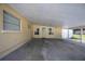 Spacious covered carport area with a doorway leading to the home's entrance at 3641 Stokes Dr, Sarasota, FL 34232