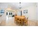 Airy dining space offers a light wood table and easy access to the living room and backyard at 3641 Stokes Dr, Sarasota, FL 34232