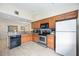 Modern kitchen with wood cabinets, breakfast bar, granite countertops, and updated appliances at 3641 Stokes Dr, Sarasota, FL 34232