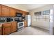 Charming kitchen with modern appliances, wood cabinets, and tile backsplash, ready for cooking at 3641 Stokes Dr, Sarasota, FL 34232