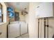 This laundry room includes a washer, dryer, shelving and water heater at 3641 Stokes Dr, Sarasota, FL 34232