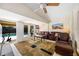 Spacious living room with sliding glass doors, ceiling fan, and view of backyard pool at 3641 Stokes Dr, Sarasota, FL 34232